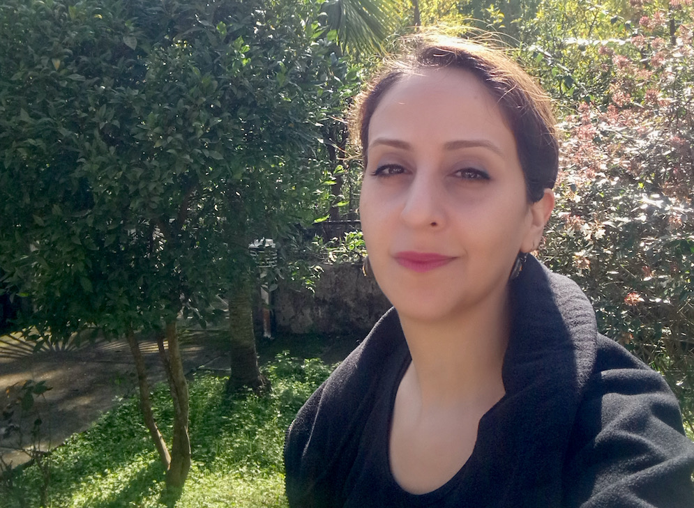 A selfie of Oldouz Nejadi-babadaei taken in a sunny garden. 